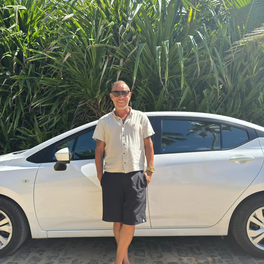 Local driver beside an Itacare Transfer sedan vehicle